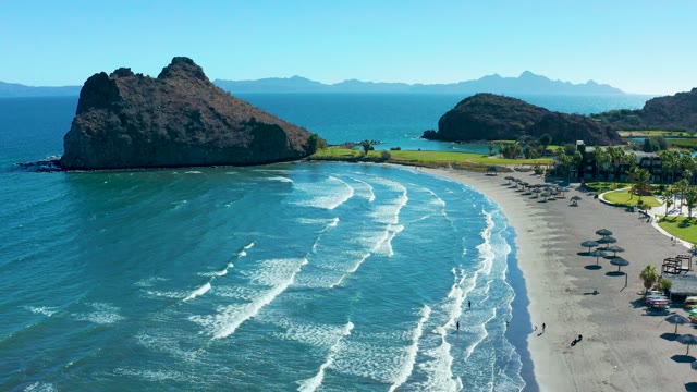 LORETO BCS MEXICO-2020: Waves Rolling Onto Sandy Beach with Rocky Headland