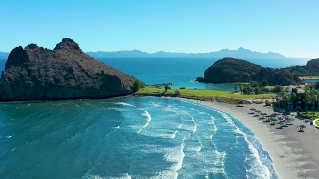 LORETO BCS MEXICO-2020: Ocean Waves Rolling Onto Sandy Shore with Beachgoers
