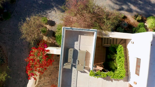 LORETO BCS MEXICO-2020: Patio with Red Flowers and White House