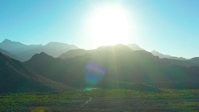 LORETO BCS MEXICO-2020: Sunlit Mountain Valley with Winding Road and Lens Flare