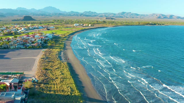 LORETO BCS MEXICO-2020: Waves Crashing on Sandy Beach with Coastal Buildings