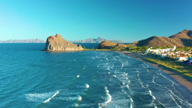 LORETO BCS MEXICO-2020: Waves Rolling Toward Sandy Beach with Rocky Outcrop