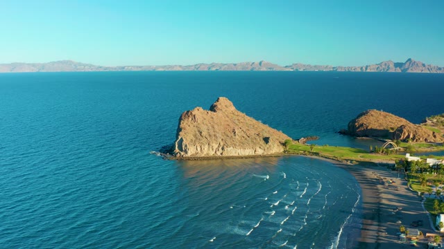 LORETO BCS MEXICO-2020: Rocky Outcrop Along Sandy Beach with Calm Ocean Waves
