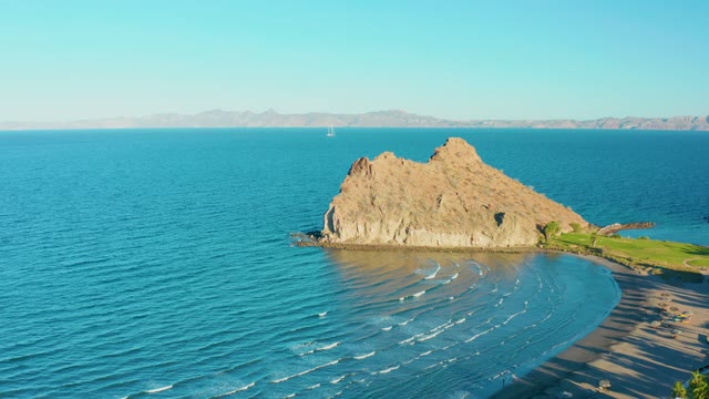 LORETO BCS MEXICO-2020: Rocky Outcrop in Ocean with Sailboat Passing by