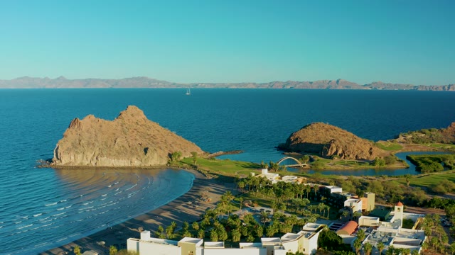 LORETO BCS MEXICO-2020: Rocky Outcrop by Sandy Beach with Coastal Buildings