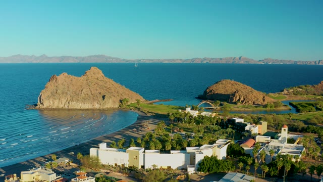 LORETO BCS MEXICO-2020: Rocky Outcrop by Beach with Coastal Buildings