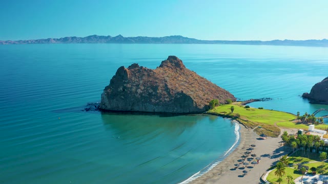 LORETO BCS MEXICO-2020: Rocky Island Beside Coastal Road and Calm Ocean