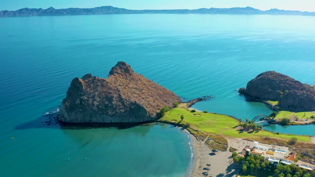 LORETO BCS MEXICO-2020: Coastal Rock Formations and Beach with Passing Boat