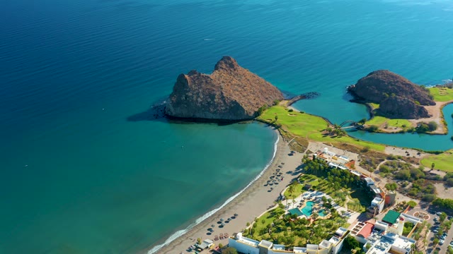 LORETO BCS MEXICO-2020: People Walking Along a Sandy Beach near Rocky Headlands