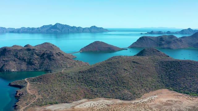 JUNCALITO BCS MEXICO-2020: Hilly Landscape with Turquoise Water and Distant Mountain Ranges