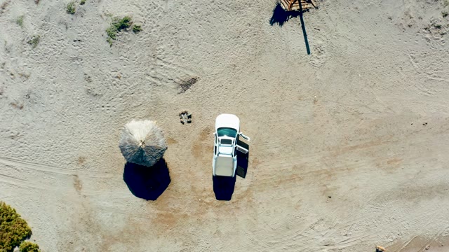 JUNCALITO BCS MEXICO-2020: Sandy Terrain with Car and Umbrella, Elements Disappearing