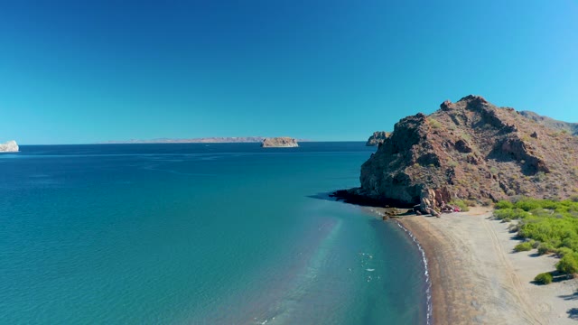 LIGUI BCS MEXICO-2020: Rocky Coastline and Distant Island by Calm Ocean