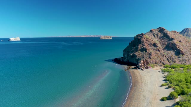LIGUI BCS MEXICO-2020: Waves Gently Lapping a Sandy Beach with Rocky Cliffs