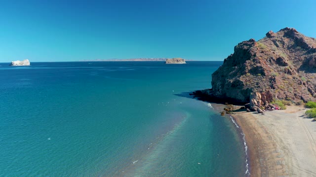 LIGUI BCS MEXICO-2020: Gentle Waves Lapping a Sandy Beach by Rocky Cliff