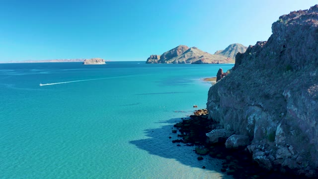 LIGUI BCS MEXICO-2020: Boat Moving with Wake Along Rocky Shore