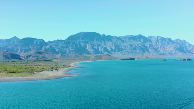 LIGUI BCS MEXICO-2020: Sandy Beach, Turquoise Water, and Distant Mountains with Moving Boat