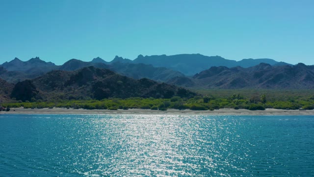 LIGUI BCS MEXICO-2020: Shimmering Ocean Waters Along Mountainous Shore