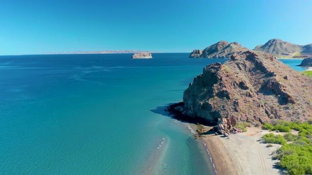 LIGUI BCS MEXICO-2020: Passing Boat Near Rocky Coast and Turquoise Water