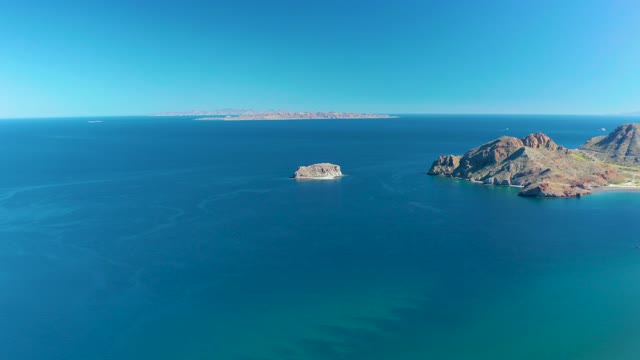 LIGUI BCS MEXICO-2020: Small Boat Moving Past Rocky Ocean Islands