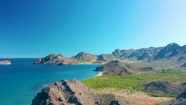 LIGUI BCS MEXICO-2020: Rocky Coastline with Turquoise Sea and Mountainous Backdrop