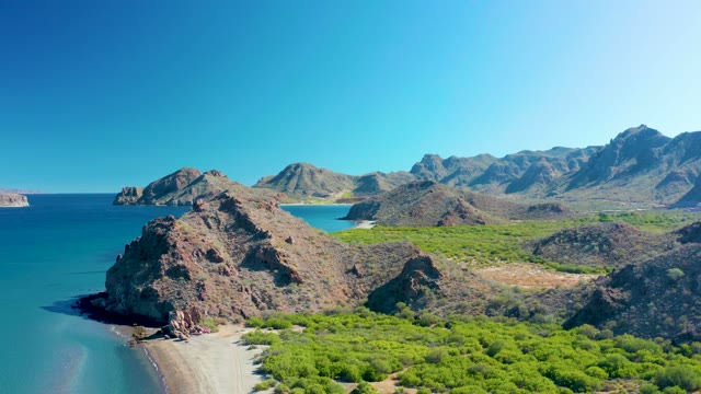 LIGUI BCS MEXICO-2020: Rocky Coastline with Sandy Beach and Mountain Backdrop