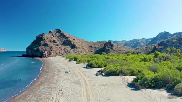LIGUI BCS MEXICO-2020: Sandy Shore with Rocky Hills and Calm Ocean