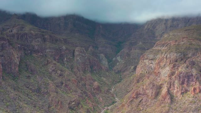 PUERTO ESCONDIDO BCS MEXICO-2020: Descending View of Mountain Valley with River and Clouds
