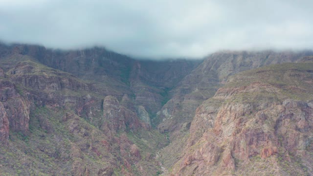 PUERTO ESCONDIDO BCS MEXICO-2020: Clouds Drifting Over Rugged Mountain Peaks