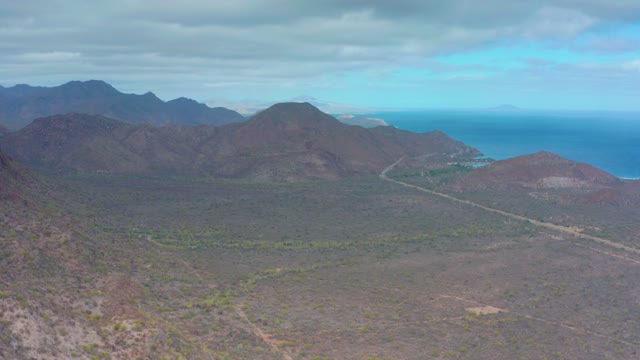 PUERTO ESCONDIDO BCS MEXICO-2020: Mountain Valley and Distant Ocean Under Cloudy Sky