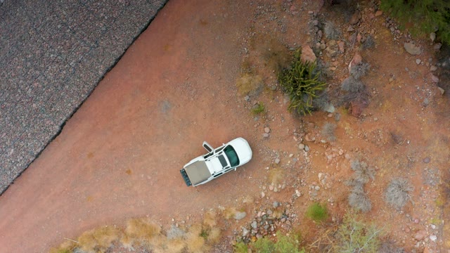 PUERTO ESCONDIDO BCS MEXICO-2020: White SUV Driving on Red Dirt Road