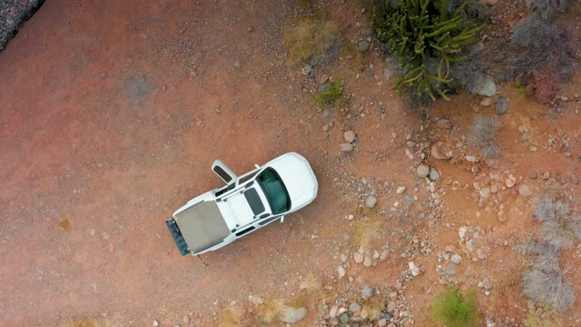 PUERTO ESCONDIDO BCS MEXICO-2020: White SUV on Red Dirt Terrain