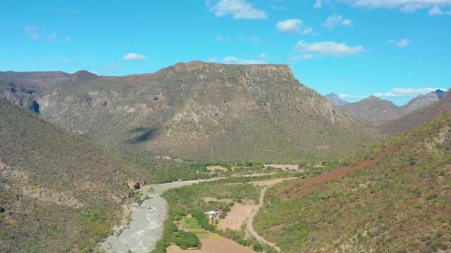 SAN JAVIER BCS MEXICO-2020: Vehicle Moving Through Mountain Valley with River