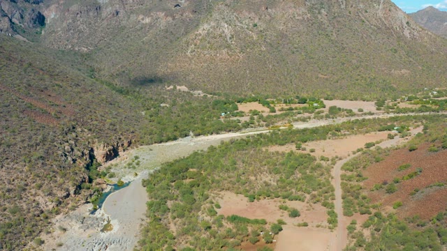SAN JAVIER BCS MEXICO-2020: Vehicle Traveling on Mountain Valley Road with River