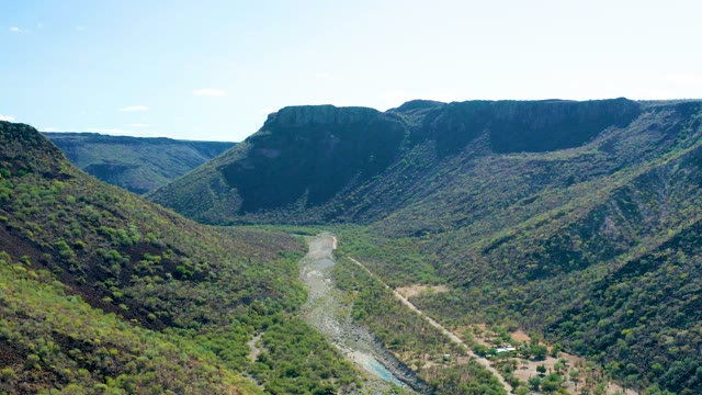 SAN JAVIER BCS MEXICO-2020: Mountain Valley with River and Moving Vehicle