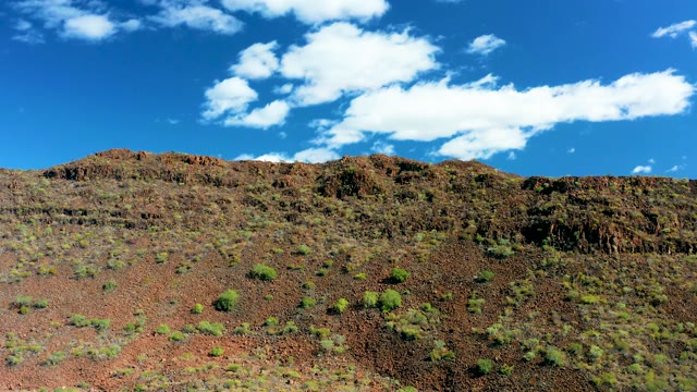 SAN JAVIER BCS MEXICO-2020: Rocky Hillside with Sparse Vegetation Under Blue Sky