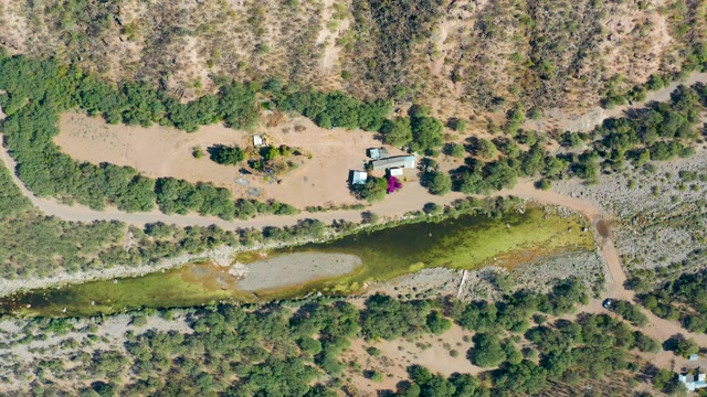 SAN JAVIER BCS MEXICO-2020: Dry Landscape with Pond and Car Moving on Dirt Path