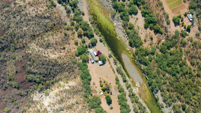 SAN JAVIER BCS MEXICO-2020: Arid Terrain with Irrigation Canal and Sparse Vegetation
