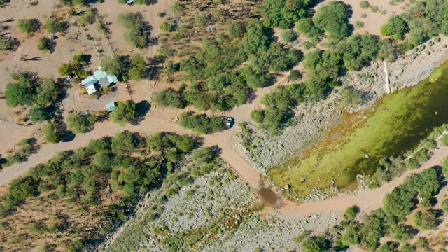 SAN JAVIER BCS MEXICO-2020: Car Moving on a Rural Road Near a River