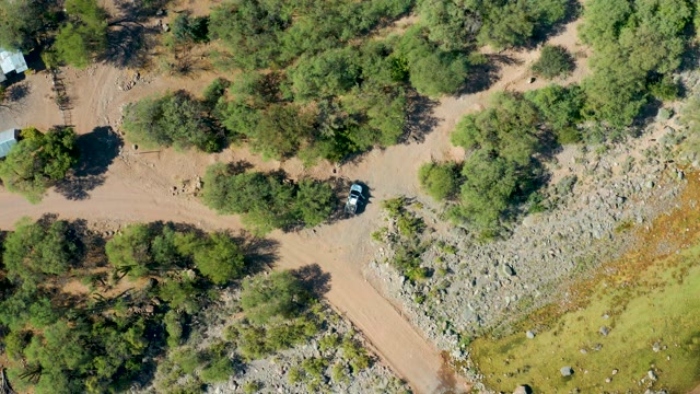 SAN JAVIER BCS MEXICO-2020: Car Driving on Forested Dirt Road Aerial