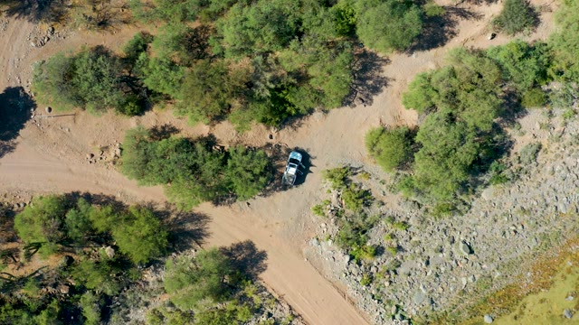SAN JAVIER BCS MEXICO-2020: Car Navigating a Dry, Tree-Dotted Path