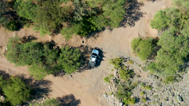 SAN JAVIER BCS MEXICO-2020: Car Moving on a Dry, Tree-dotted Dirt Trail