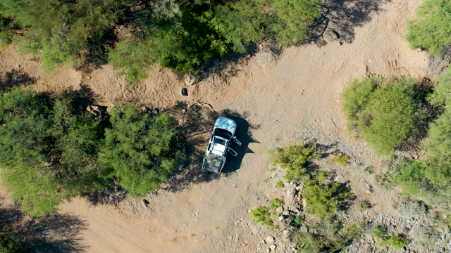SAN JAVIER BCS MEXICO-2020: Car Driving Through Arid Tree-Dotted Terrain