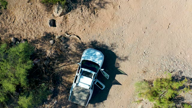 SAN JAVIER BCS MEXICO-2020: White SUV with Open Door in Arid Landscape