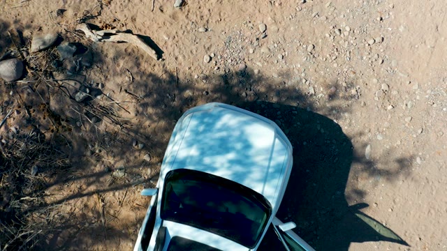 SAN JAVIER BCS MEXICO-2020: White Car in Dry Rocky Terrain Overhead