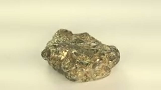 WESTMINSTER COLORADO-2015: Precious Gold Coloured Rock Being Rotated On Display