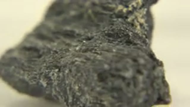WESTMINSTER COLORADO-2015: Close Up Rotating Black Rock On A White Surface