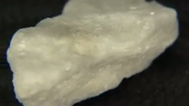 WESTMINSTER COLORADO-2015: White Rock With Sparkles Rotating On Dark Pedestal