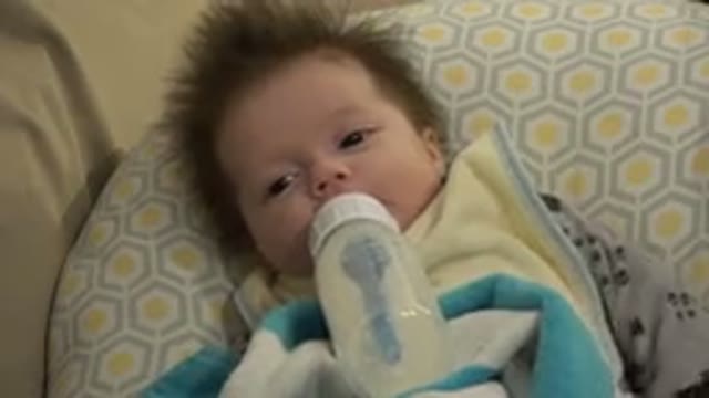 WESTMINSTER COLORADO-2015: A Young Baby Lays On Pillow While Nursing From A Bottle