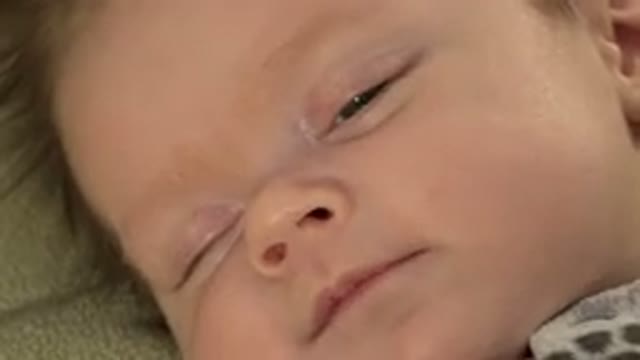 WESTMINSTER COLORADO-2015: A White Little Baby Moving His Head And Face While Sleeping
