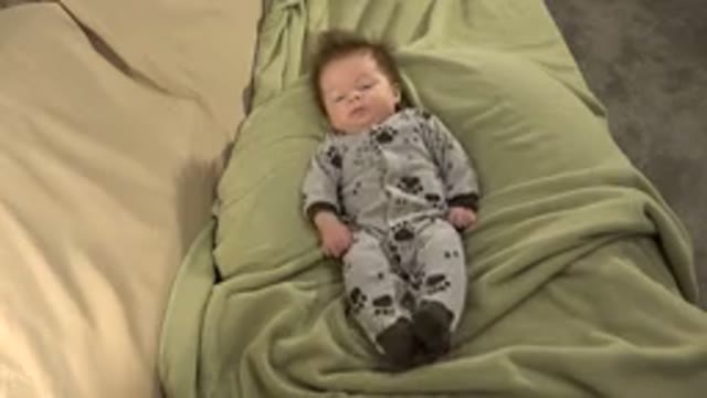 WESTMINSTER COLORADO-2015: Baby in Grey Pajamas on Green Mattress Gesturing